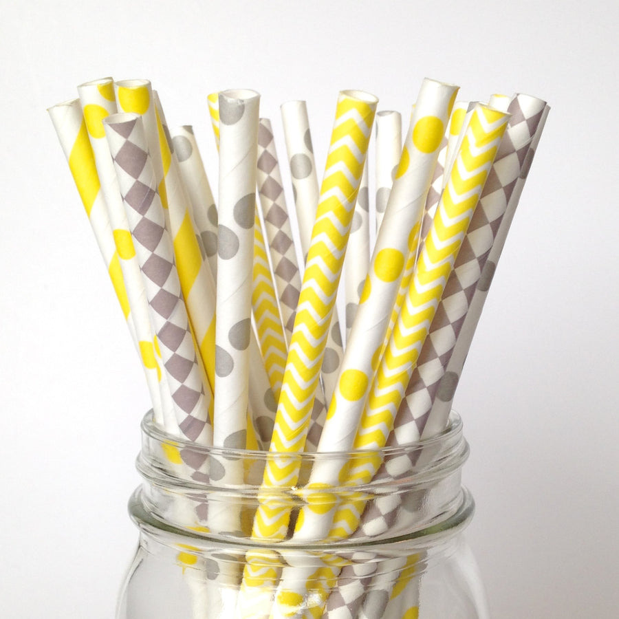 Single yellow drinking cocktail straw decorated with pink flamingo